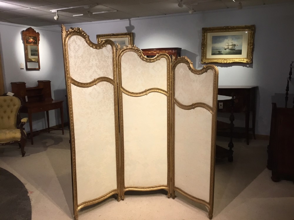 A carved gilt-wood French three fold vanity screen. 
