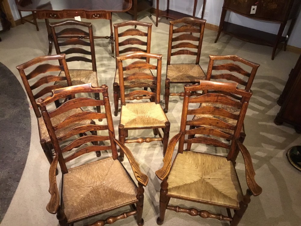 A Good harlequin set of 8 mid 19th Century ash and elm Billinge ladder back dining chairs