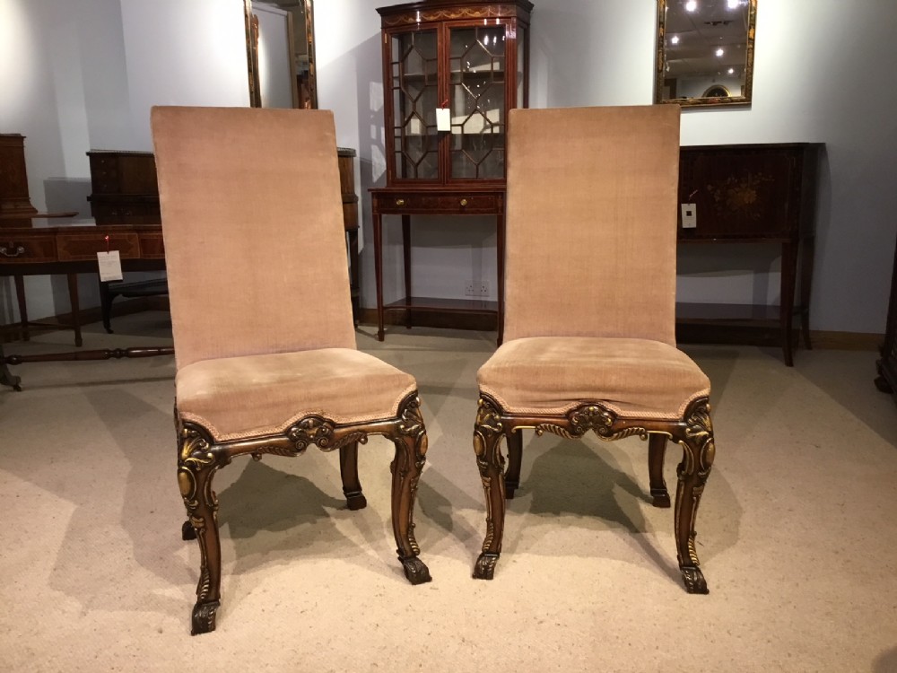 A good pair of walnut & parcel gilt George I Style hall chairs