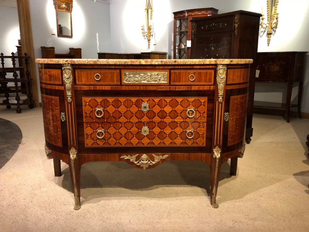 A beautiful French Louis XVI Style marble topped marquetry inlaid commode