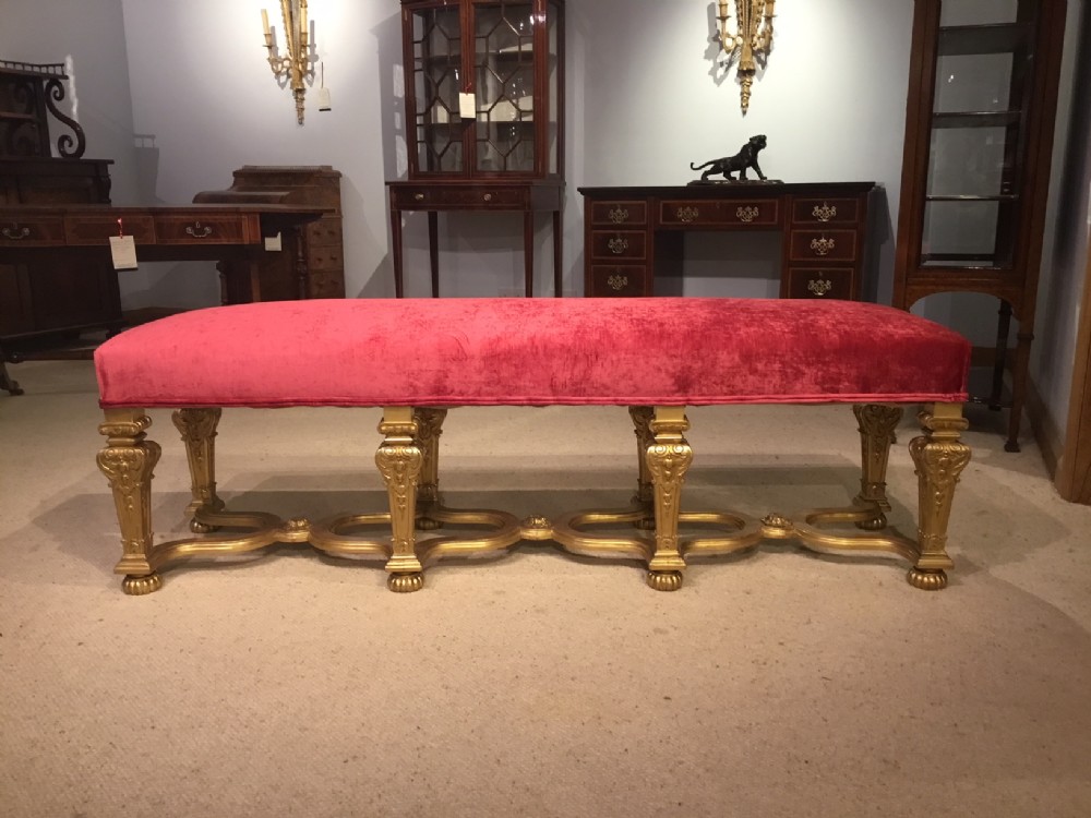 An 8 leg carved gilt wood George II Style country house stool