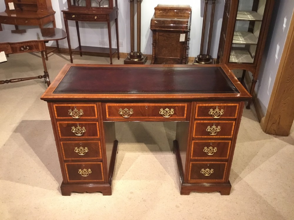 A good mahogany inlaid Edwardian Period pedestal desk