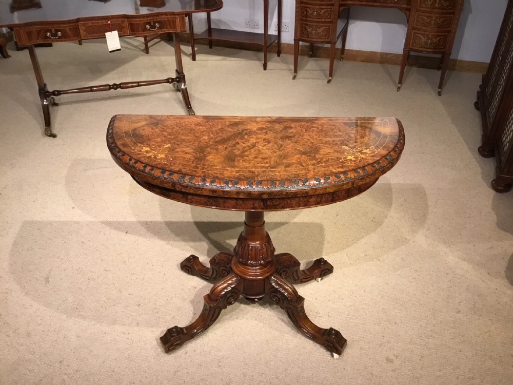 A Fine Quality burr walnut and marquetry inlaid Victorian Period games table.