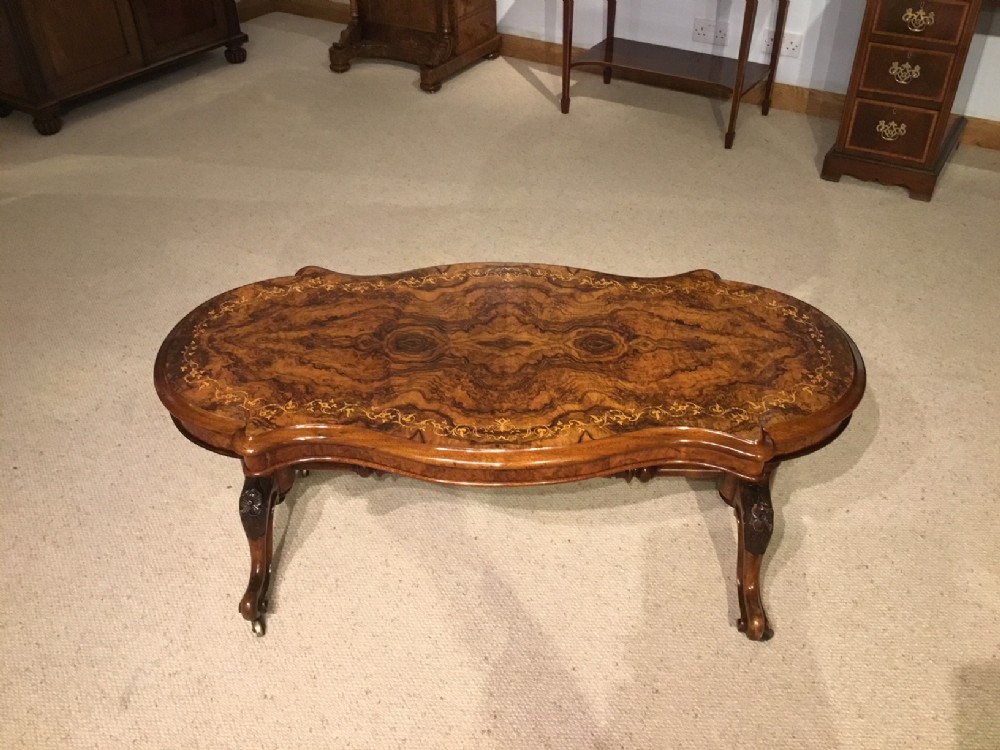 A superb burr walnut Victorian Period serpentine coffee table