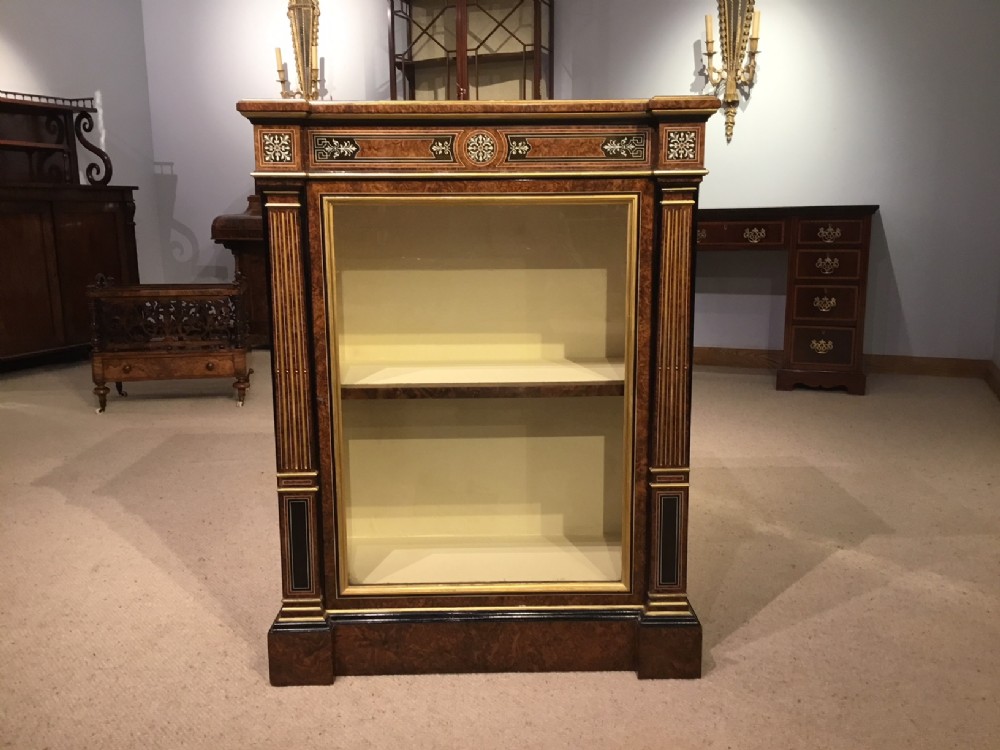 An exhibition quality burr walnut and ivory inlaid Victorian Period pier cabinet.