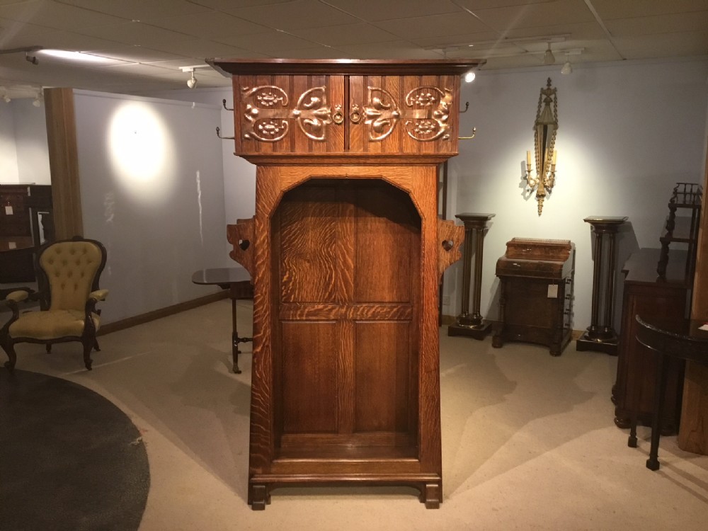 A rare oak Arts & Crafts Period hall robe by Shapland & Petter of Barnstaple