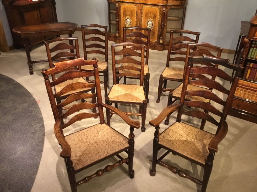 A harlequin set of 8 Early 19th Century ash and elm ladder back kitchen dining chairs