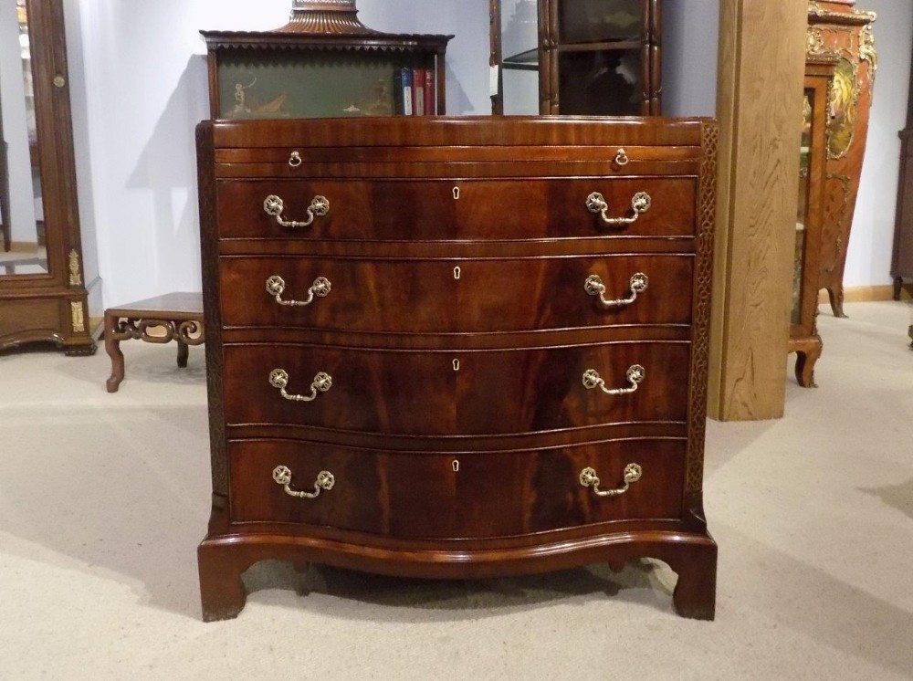 A mahogany Chippendale Style serpentine antique bachelors chest of drawers. 