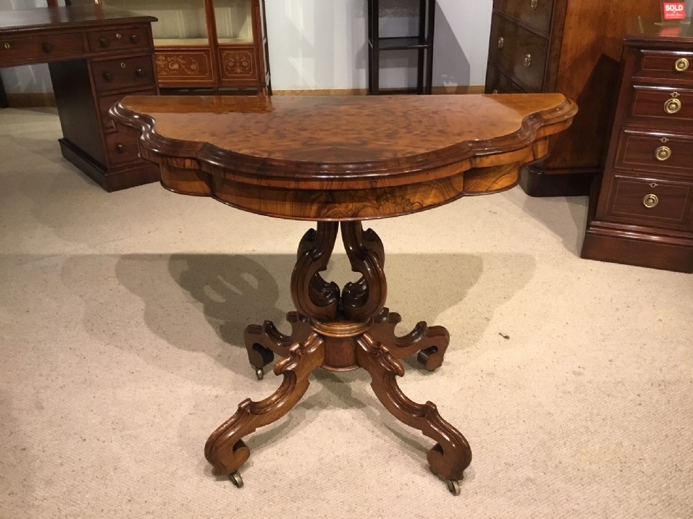 A figured walnut & walnut Victorian Period fold over card table