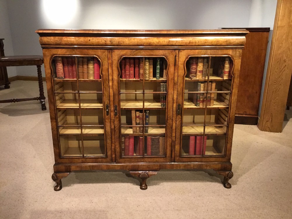 A walnut Queen Anne Revival three door bookcase.