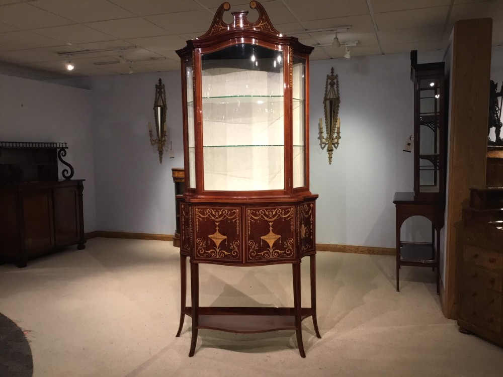 A Fine Quality marquetry inlaid Edwardian Period serpentine cabinet by Maple & Co Of London