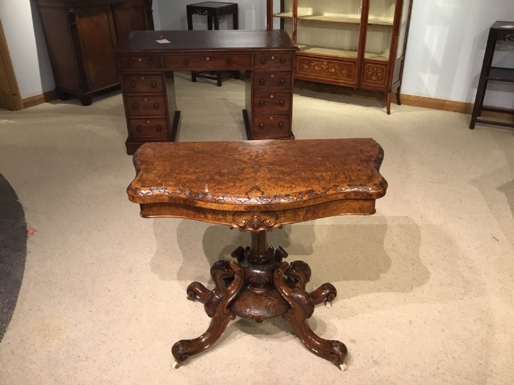 A burr walnut Victorian Period fold over card table