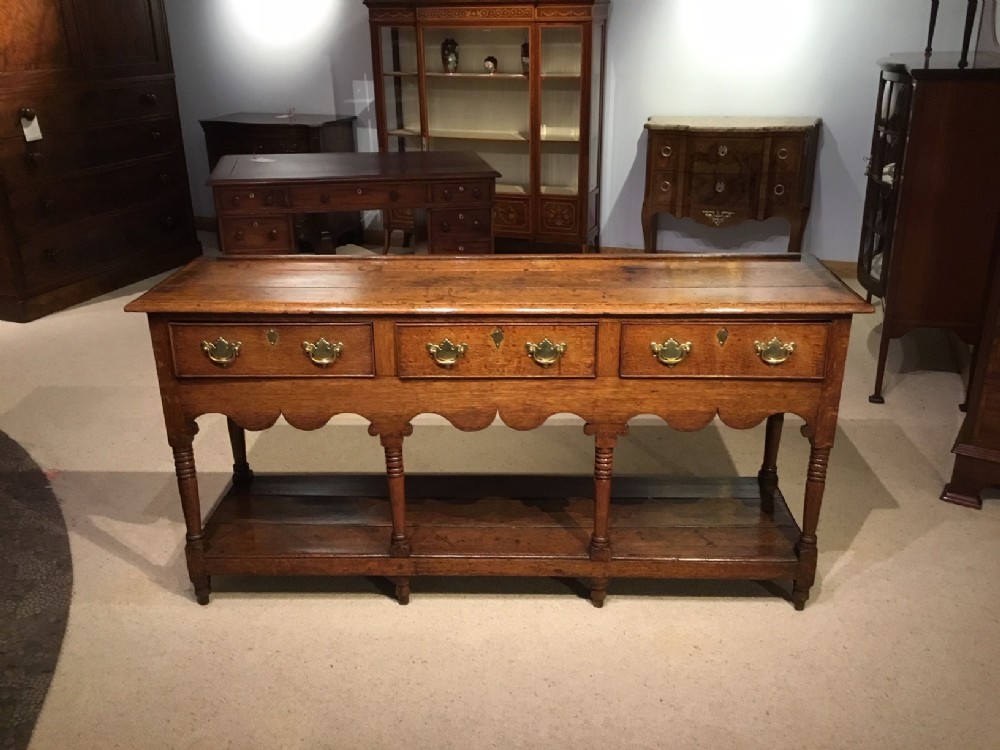 An oak early 19th Century pot board antique dresser base