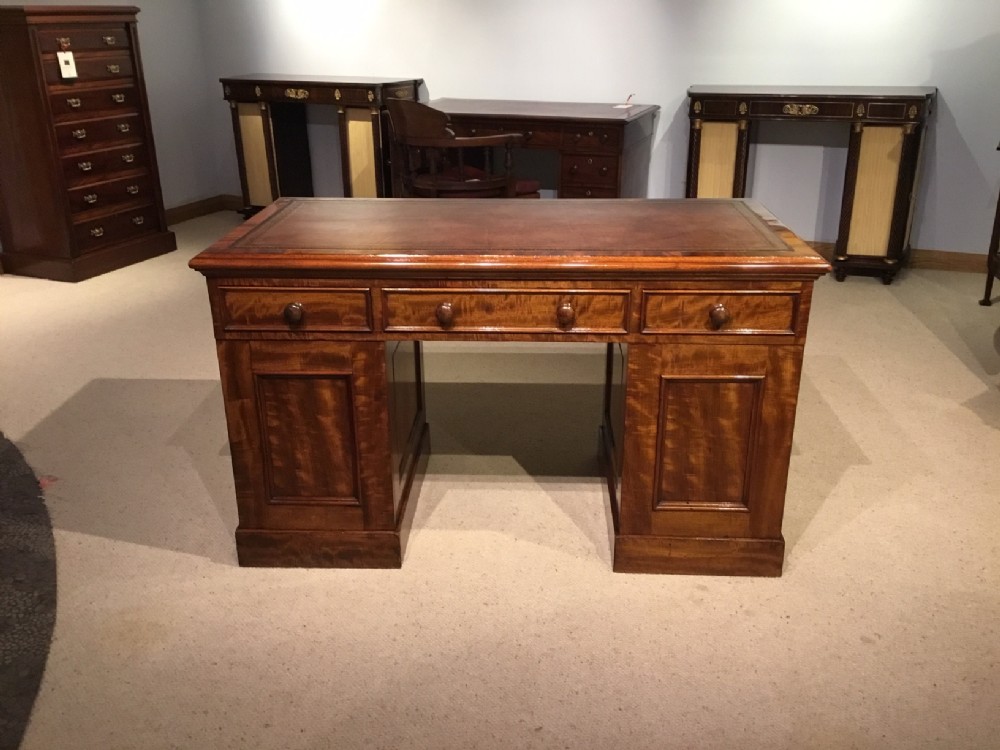 A figured mahogany Victorian Period antique writing desk.