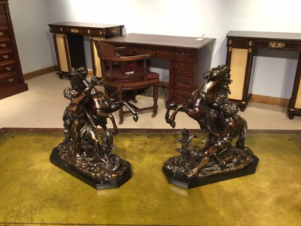 A pair of French Classical 19th Century bronze Marley horses after Coustou