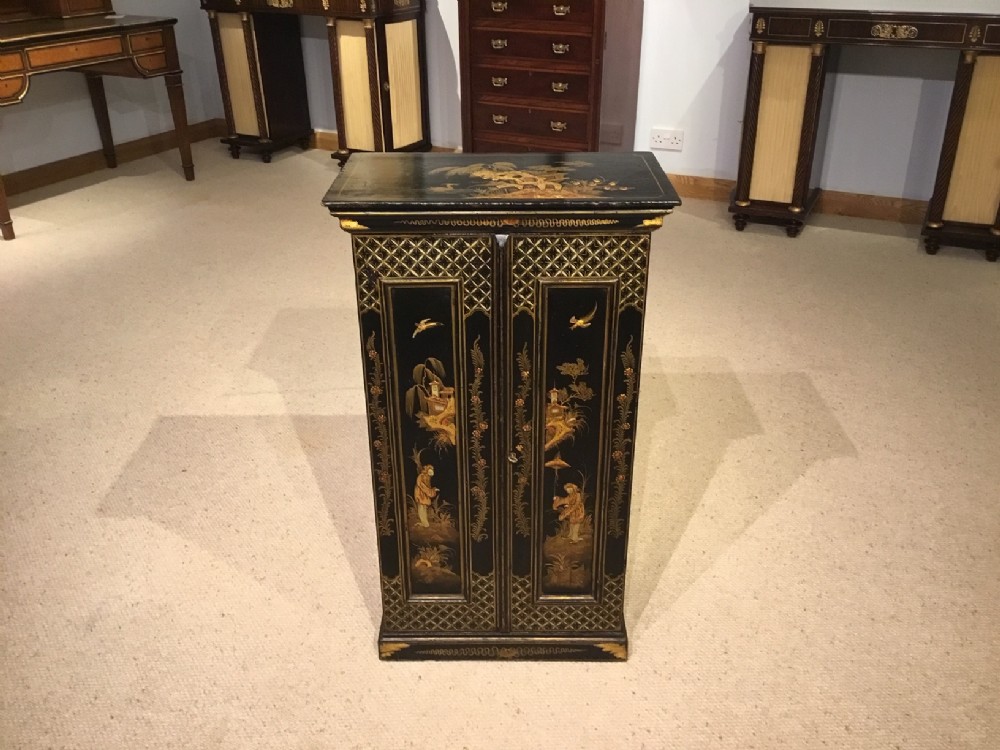 A small chinoiserie lacquered 1920s antique cupboard