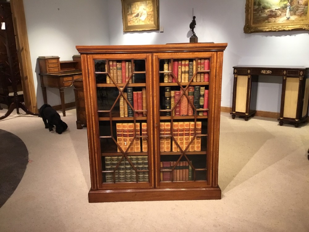 A mahogany and satinwood inlaid Edwardian Period antique bookcase
