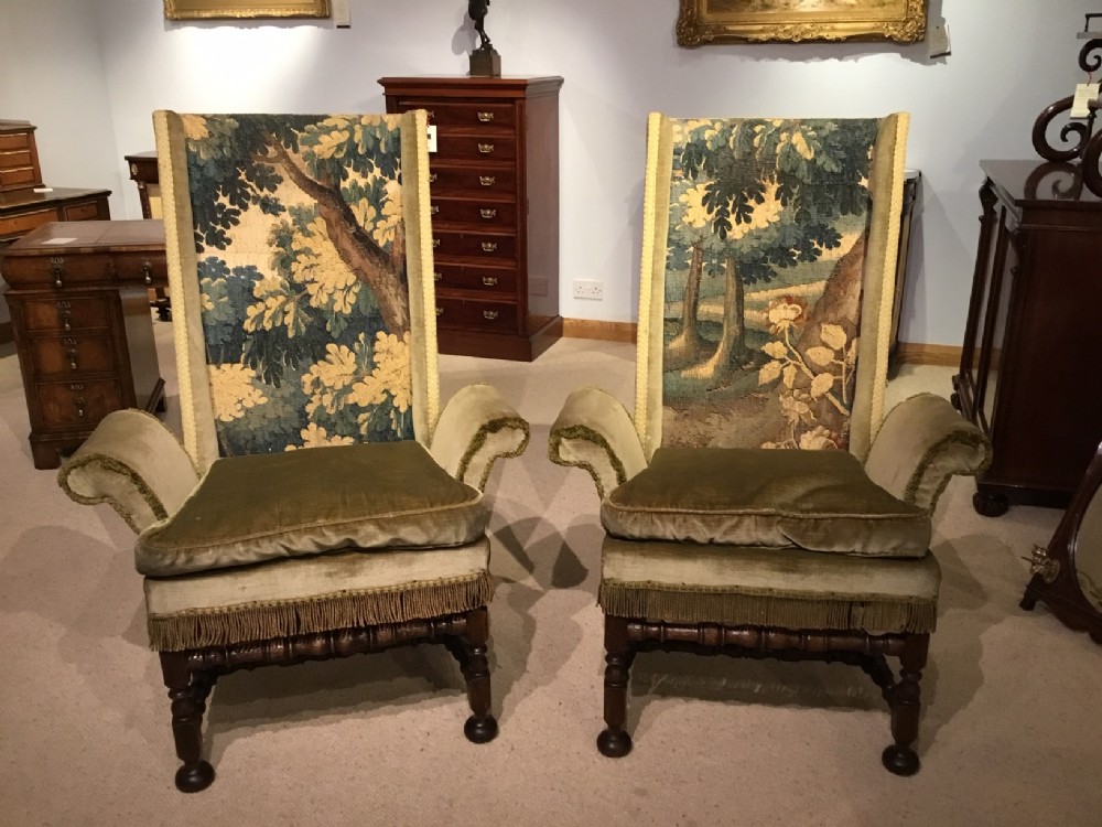 A pair of oak and tapestry 18th Century style armchairs.