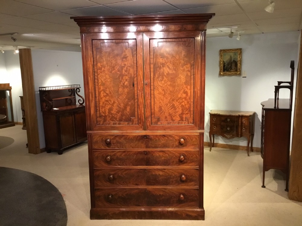 A Regency Period flame mahogany press cupboard in the manner of Gillows.
