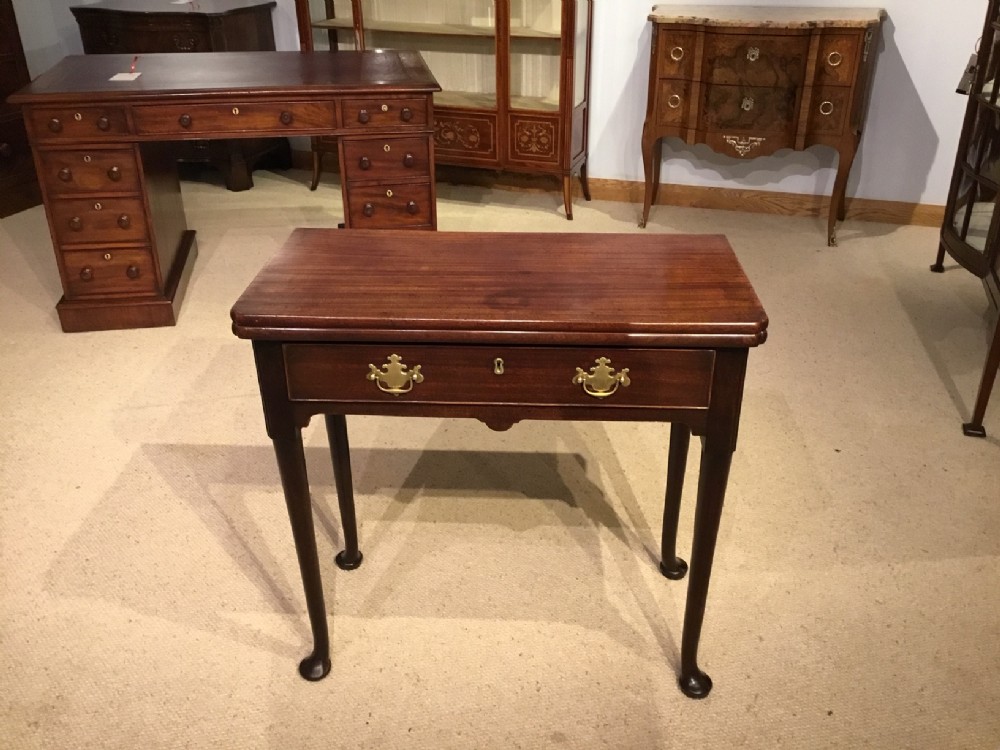 A mahogany George II Period fold over tea table.