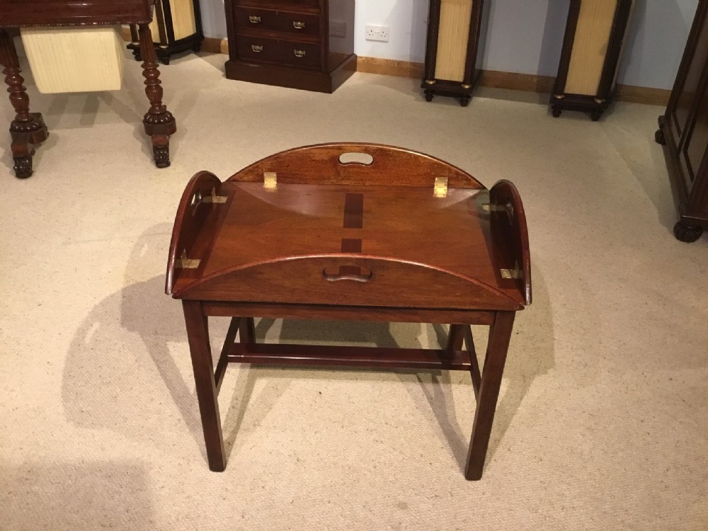 A mahogany 19th Century folding butlers tray on stand
