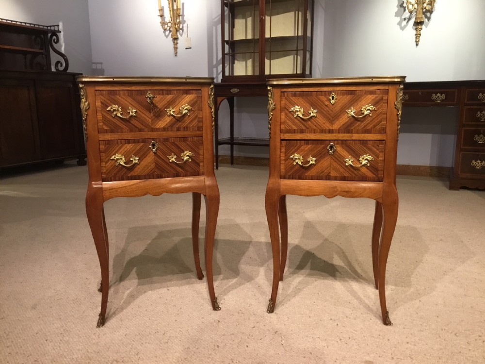 A pair of kingwood and parquetry French antique bedside cabinets