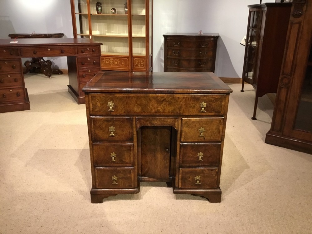 A Small Queen Anne Style burr walnut knee hole desk