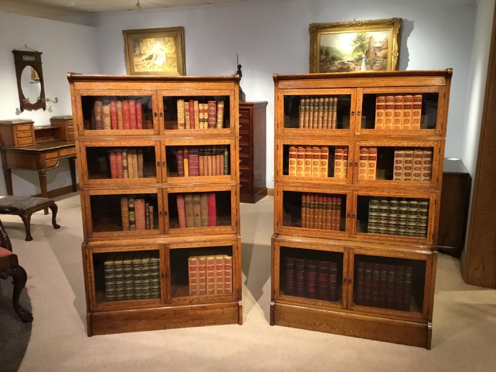 A pair of oak sectional bookcases by William Baker & Co of Oxford