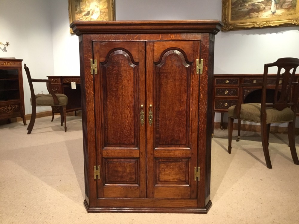 An oak George III Period double door antique corner cupboard