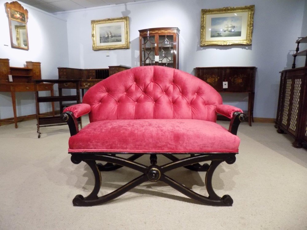 A Victorian Aesthetic Period ebonised and gilt sofa