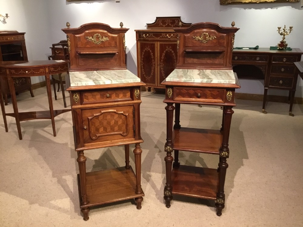A matched pair of French mahogany and ormolu mounted antique bedside cabinets