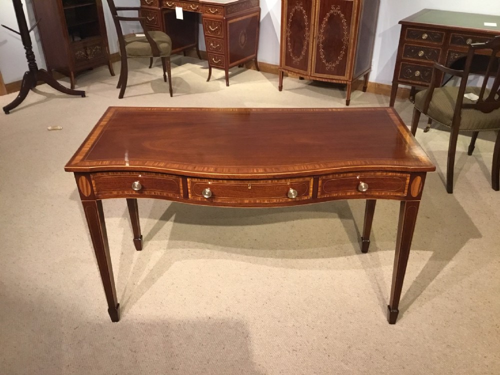 A beautiful mahogany Edwardian Period serpentine side table by Edwards & Roberts of London