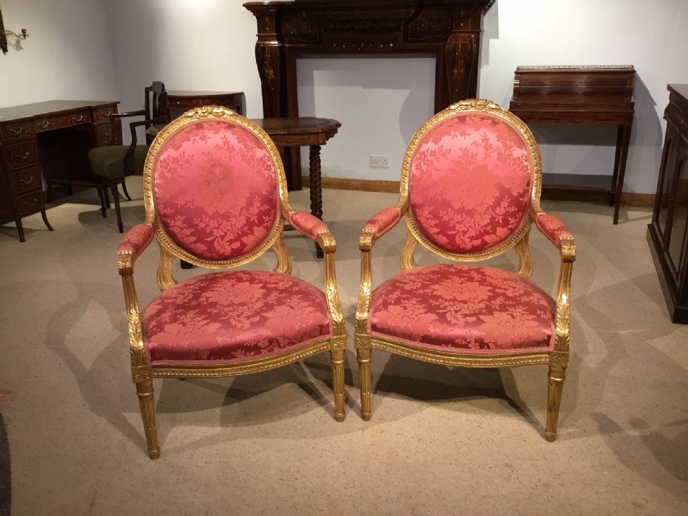 A pair of Louis XVI style carved gilt-wood fauteuils