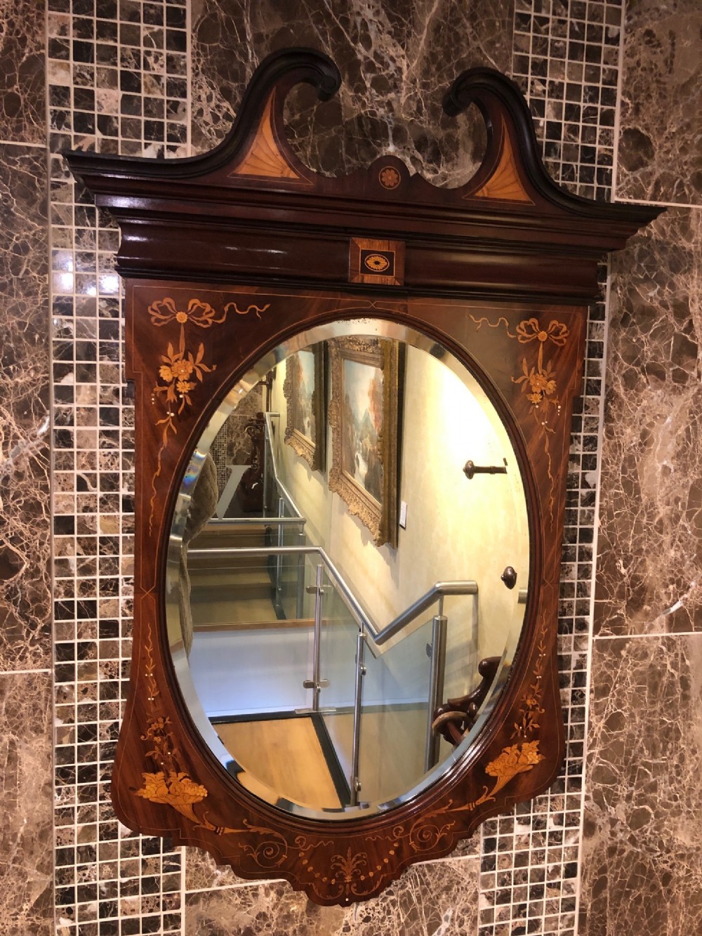 A marquetry inlaid Edwardian Period antique wall mirror.