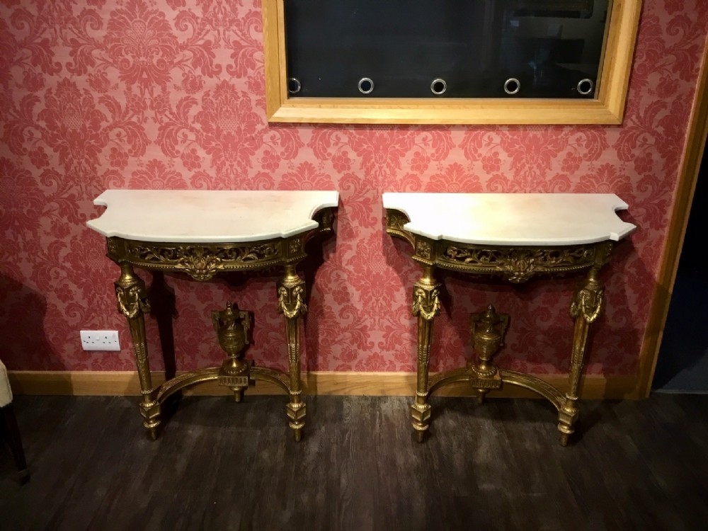 A Fine quality pair of 19th Century Louis XVI Style carved gilt-wood and gesso console tables.