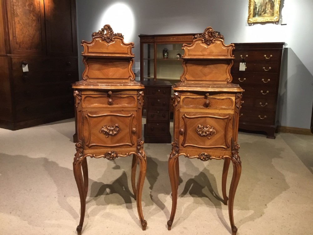 A pair of marble top French Late 19th Century bedside cabinets.