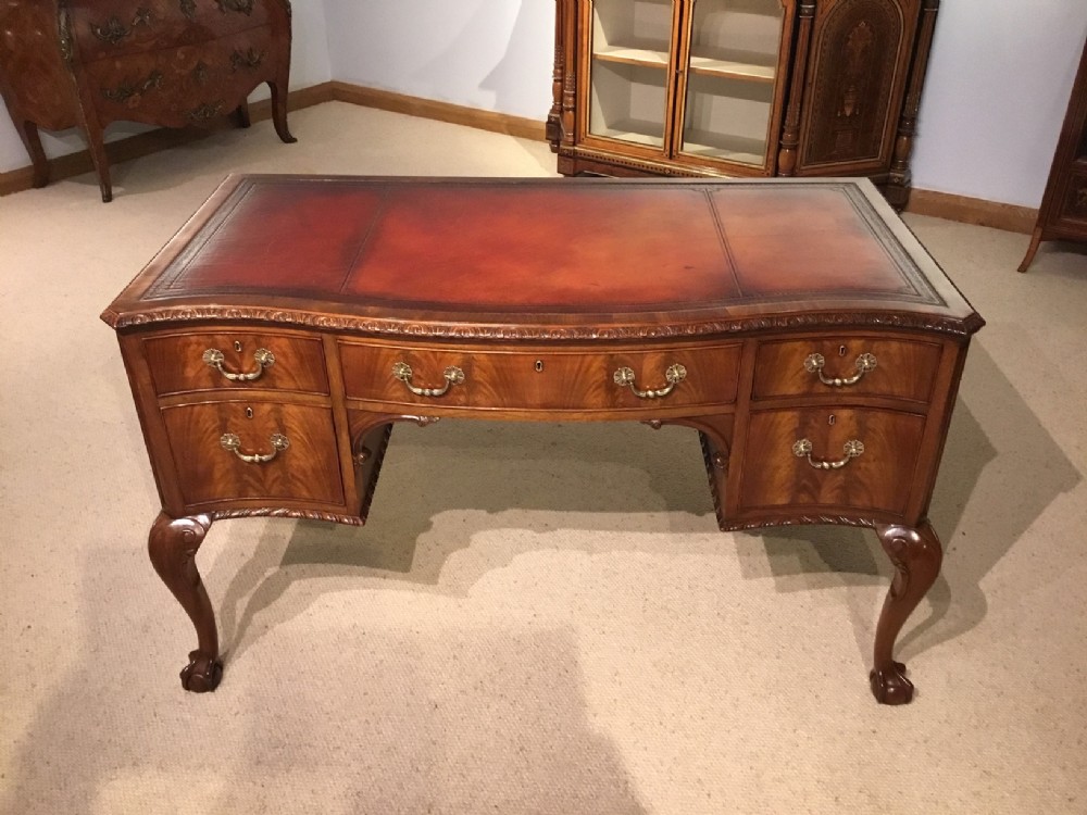 An Edwardian Period flamed mahogany Chippendale Style desk