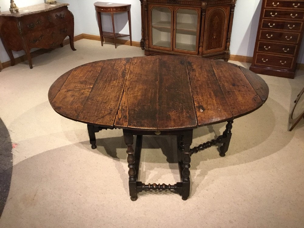 An oak Late 17th Century 6-8 seater oval gate leg dining table