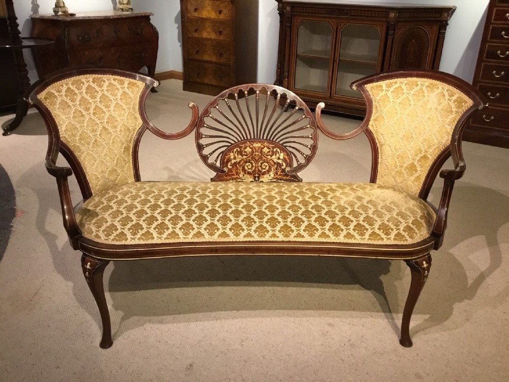 A mahogany and marquetry inlaid Edwardian Period settee