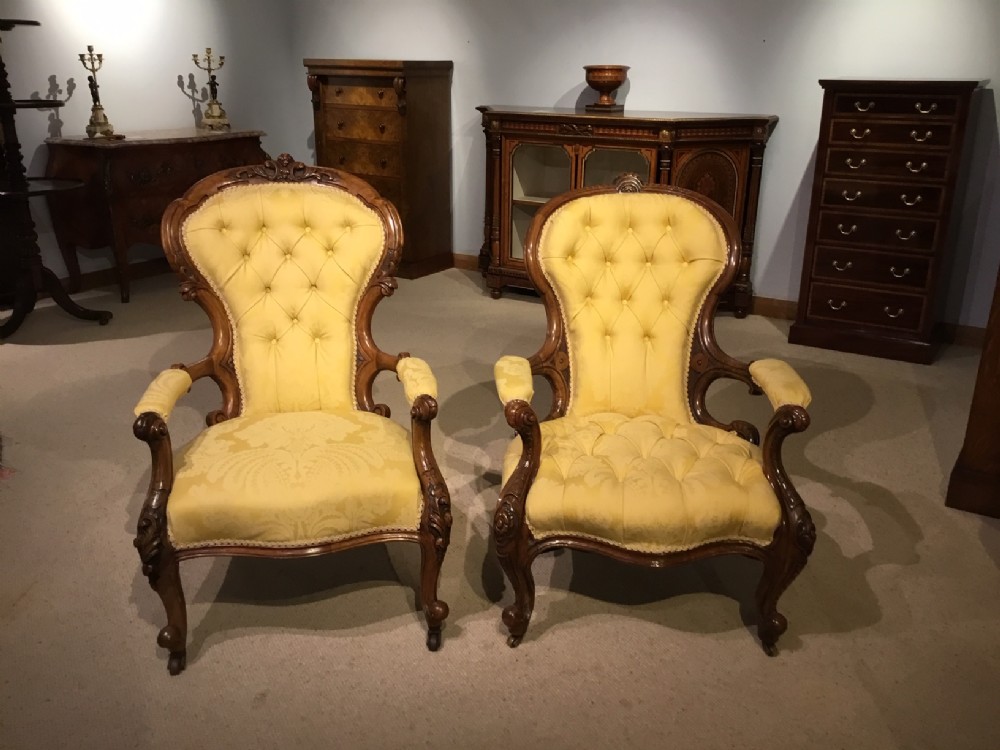 A good near pair of Victorian Period carved walnut antique armchairs