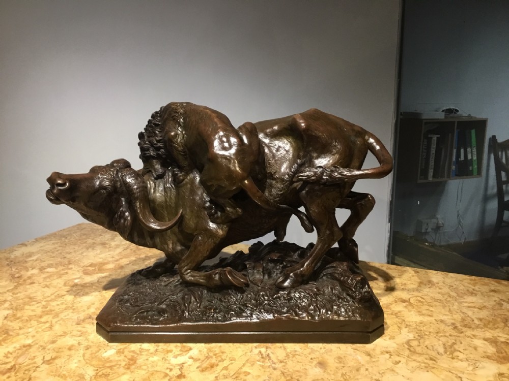 A large 19th Century French bronze animalier group depicting a bull and a lion
