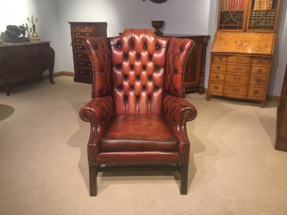  A 1920s Period red leather deep buttoned gentleman's wing armchair