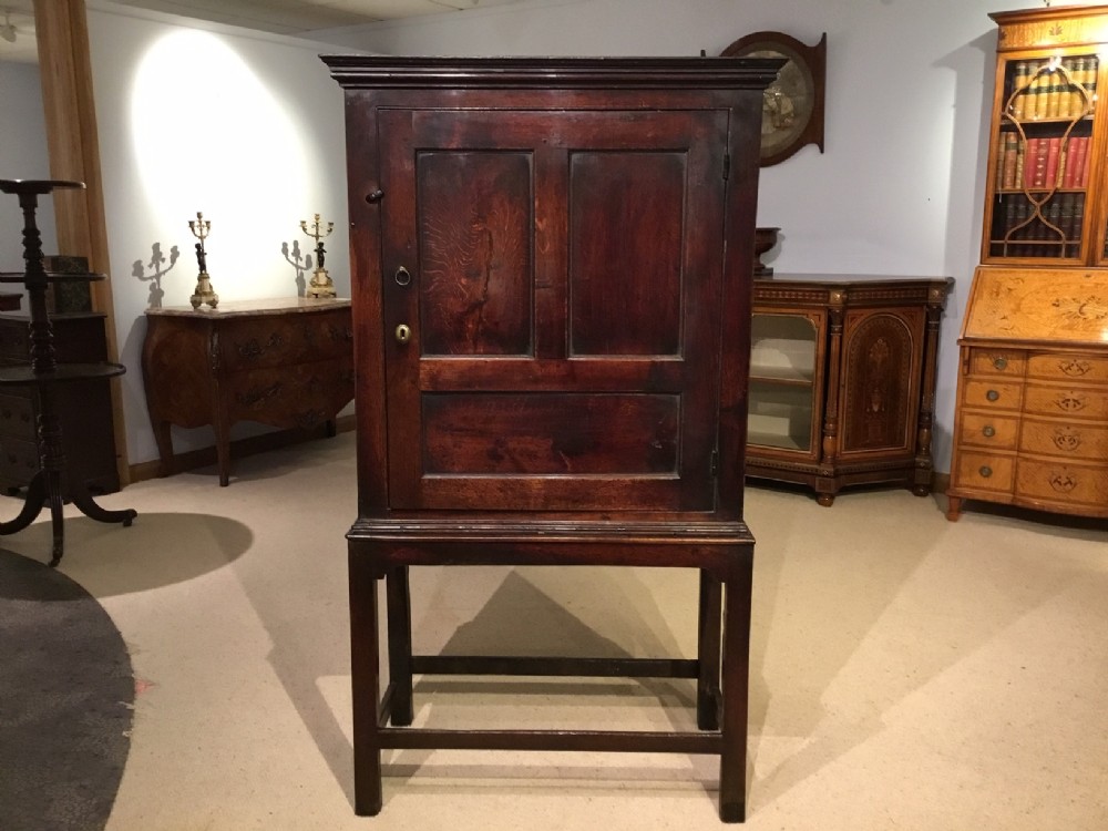 A charming oak 18th Century cupboard on stand