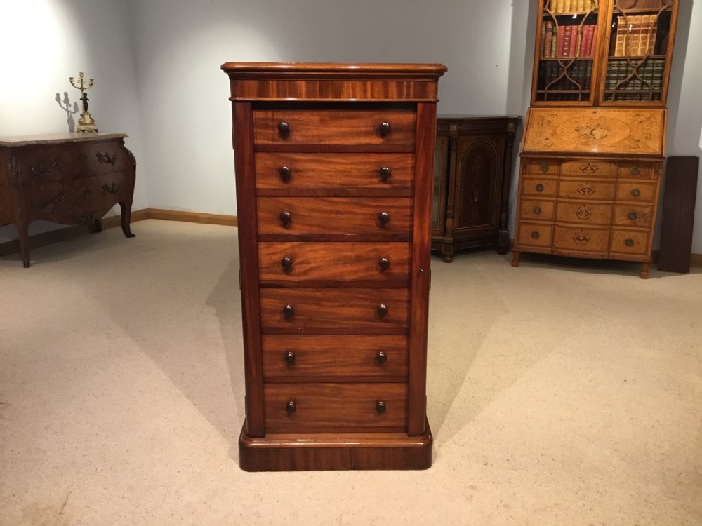 A figured mahogany Victorian Period antique wellington chest.