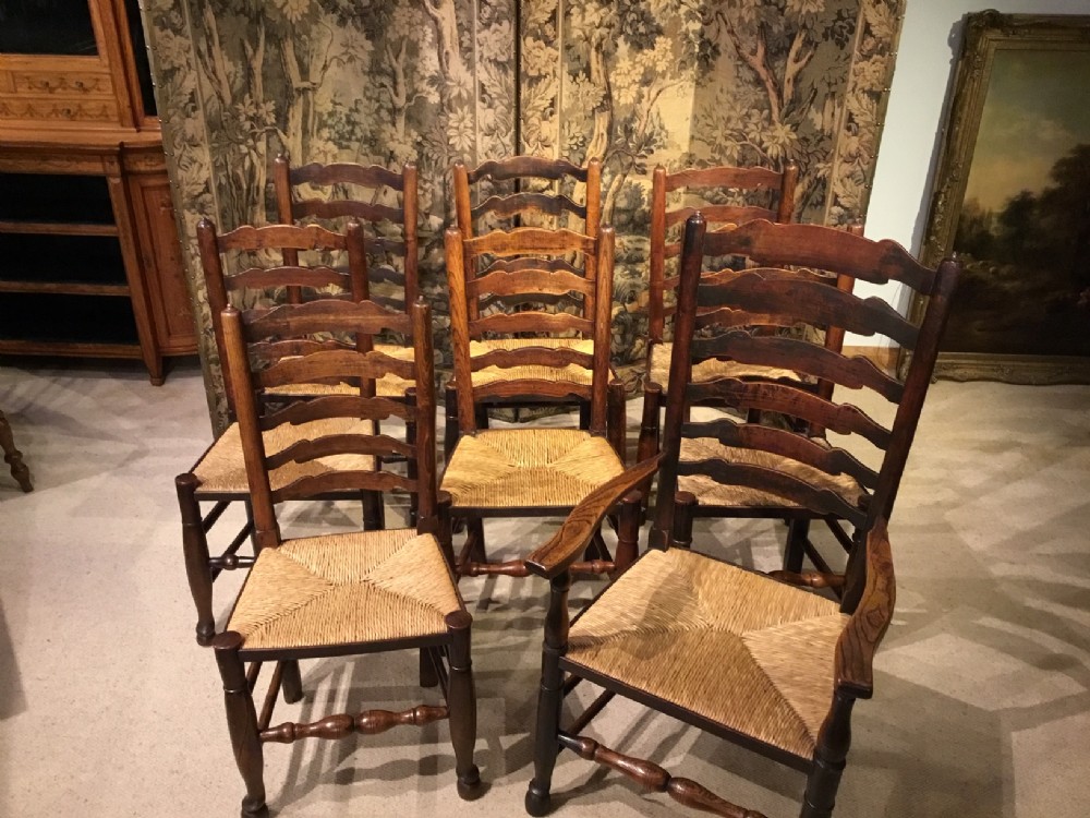 A set of 8 19th Century ash and elm ladder back dining chairs