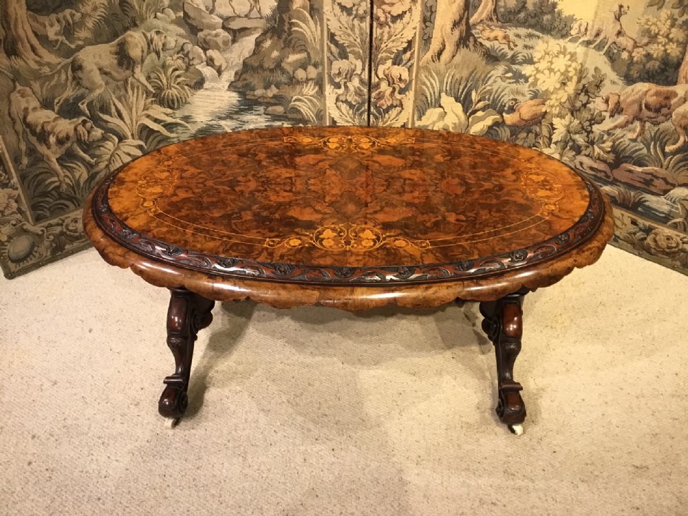 A Victorian Period oval burr walnut marquetry inlaid antique coffee table