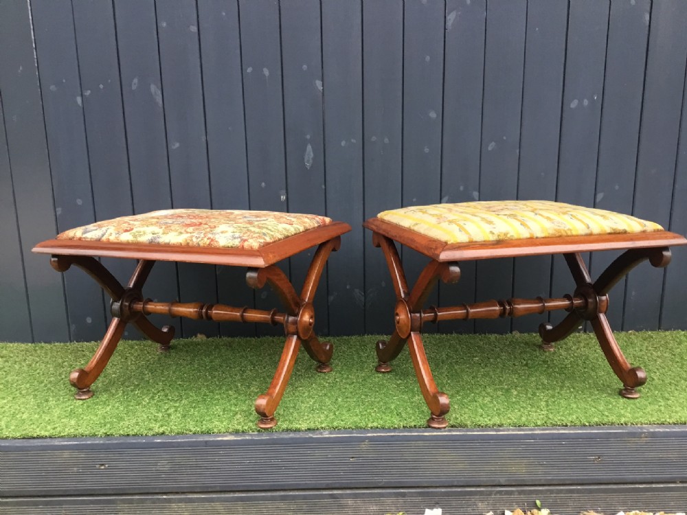 A pair of fine quality of rosewood Regency Period X framed stools