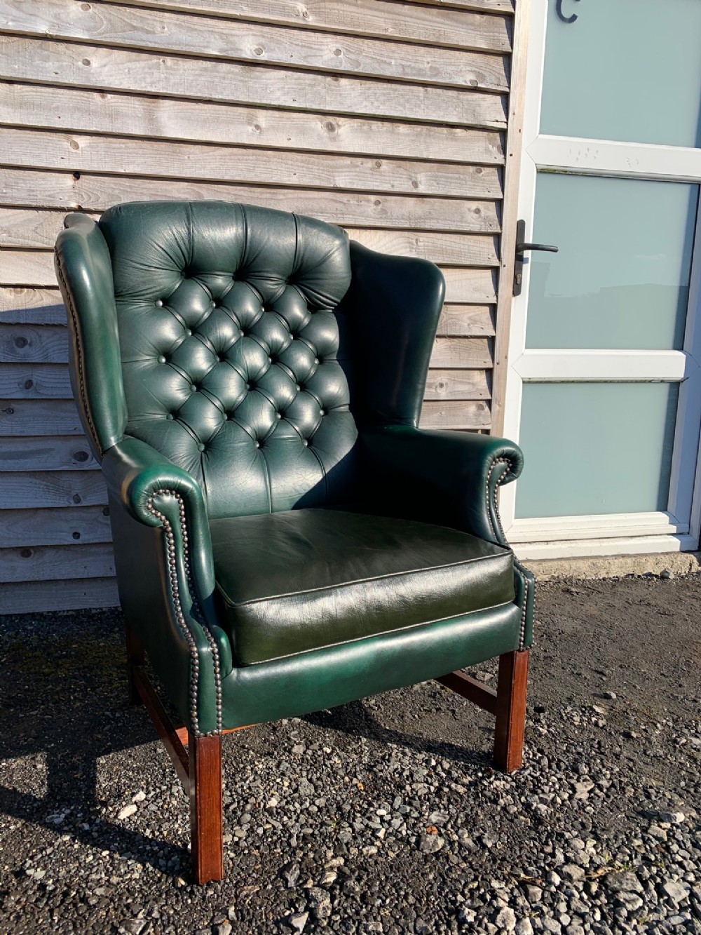 A Georgian Style mahogany style wing armchair