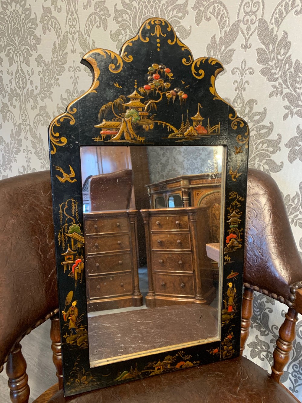 A small Edwardian Period ebonised and Chinoiserie wall mirror