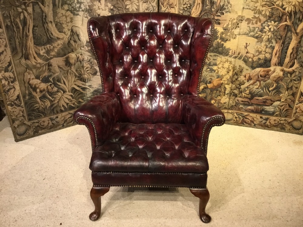 A red leather Georgian Style wing armchair